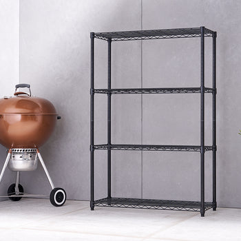 A four-tiered black wire shelving unit stands next to a shiny copper-colored charcoal grill with wheels. A green succulent plant in a gray pot is on the opposite side of the shelving unit.