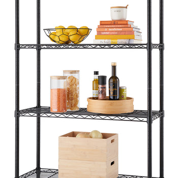 A four-tiered, black wire shelving unit is shown against a white background. The shelves are organized with various items, including bowls of lemons, a stack of cookbooks, glass containers of food, and two wooden boxes.