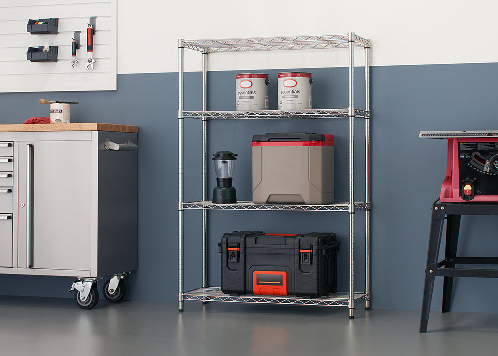 A close-up, eye-level shot shows a shiny, four-tier chrome wire shelving unit. The unit holds various garage and camping supplies, including two cans of paint on the top shelf, a lantern and a cooler on the second, and a black and orange tool case on the bottom.