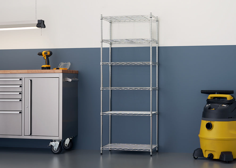 A vertical shot of an empty five-shelf, wire-rack unit with a shiny chrome finish. The shelving unit is against a two-toned wall, with the bottom half painted a dark blue and the top a light off-white color.
