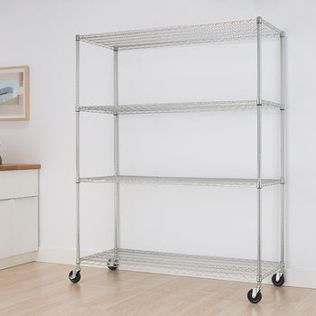 A silver metal wire shelving unit with four tiers stands against a white wall in a room. The unit has wheels at the bottom for mobility and is partially filled with items.