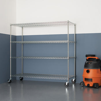 A chrome wire shelving unit with four tiers and wheels stands against a two-toned wall, next to an orange and black wet/dry vacuum. The shelving unit is empty and the floor is a glossy gray.