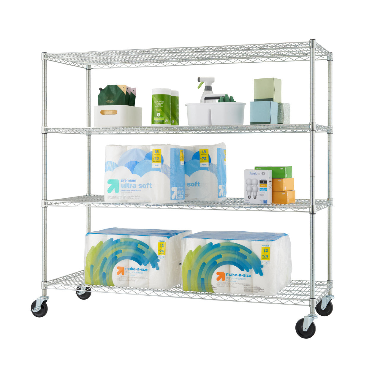 A silver, four-tiered wire shelving unit on wheels is shown against a white background. The shelves are filled with various household items, including toilet paper, cleaning supplies, and boxes.