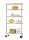 A full-height, five-tier chrome wire shelving unit is on wheels. The shelves are organized with kitchen items, including serving dishes, food canisters, and woven baskets.