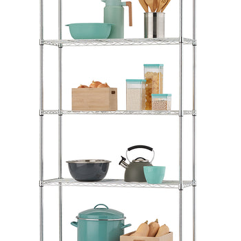 A chrome-plated wire shelving unit stands against a white background, neatly organized with various kitchen essentials on its five tiers. Shelves display items including teal mixing bowls and a carafe, wooden cooking utensils, stacked dried pasta and rice containers, a wooden bin of onions, a charcoal mixing bowl, a grey stovetop kettle, a large teal stockpot, and a wooden bin of butternut squash.