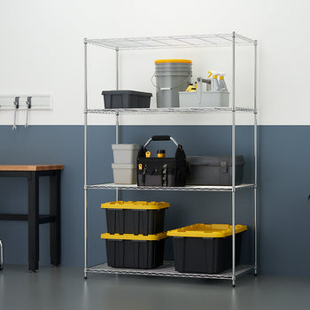 A well-organized garage or workshop space is shown, featuring a five-shelf chrome wire shelving unit stocked with various storage containers, a tool tote, and buckets. To the left is a wooden-top workbench with a metal frame, a rolling stool, a magnetic tool rail with hand tools, and a large trash can to the right, all set against a white and gray wall.
