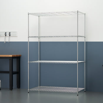 An empty five-tier chrome wire shelving unit stands against a two-tone white and blue wall in a garage-like setting. To the left is a wooden workbench with tools hanging on a rail above it, and to the right is a large grey plastic storage bin.