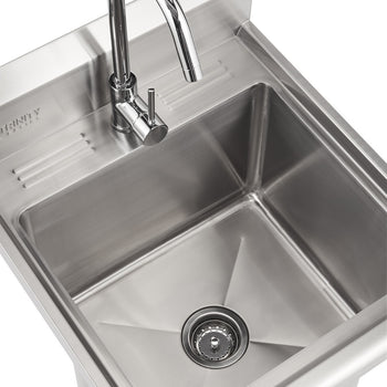 A close-up shot of a 13 inch deep clean, stainless steel utility sink with a chrome faucet mounted at the top left. The sink basin is empty and features a round drain with a strainer in the center.