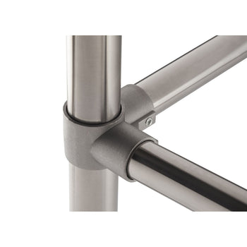 A close-up shows a metal joint connecting three cylindrical metal tubes. The joint is a matte gray, while the tubes are shiny silver.