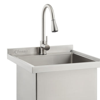 A close-up shot shows a Trinity brand stainless steel utility sink featuring a high-arc, brushed nickel pull-down faucet. The industrial-style sink includes a small backsplash with the company logo engraved on the left side.