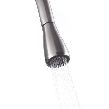 Close-up view of a stainless steel pull-out faucet head dispensing water. The water streams down from the numerous small nozzles, creating a focused spray.