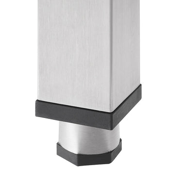 A close-up shot of a stainless steel table leg with a black plastic foot. The leg is square and the foot is a hexagonal shape.