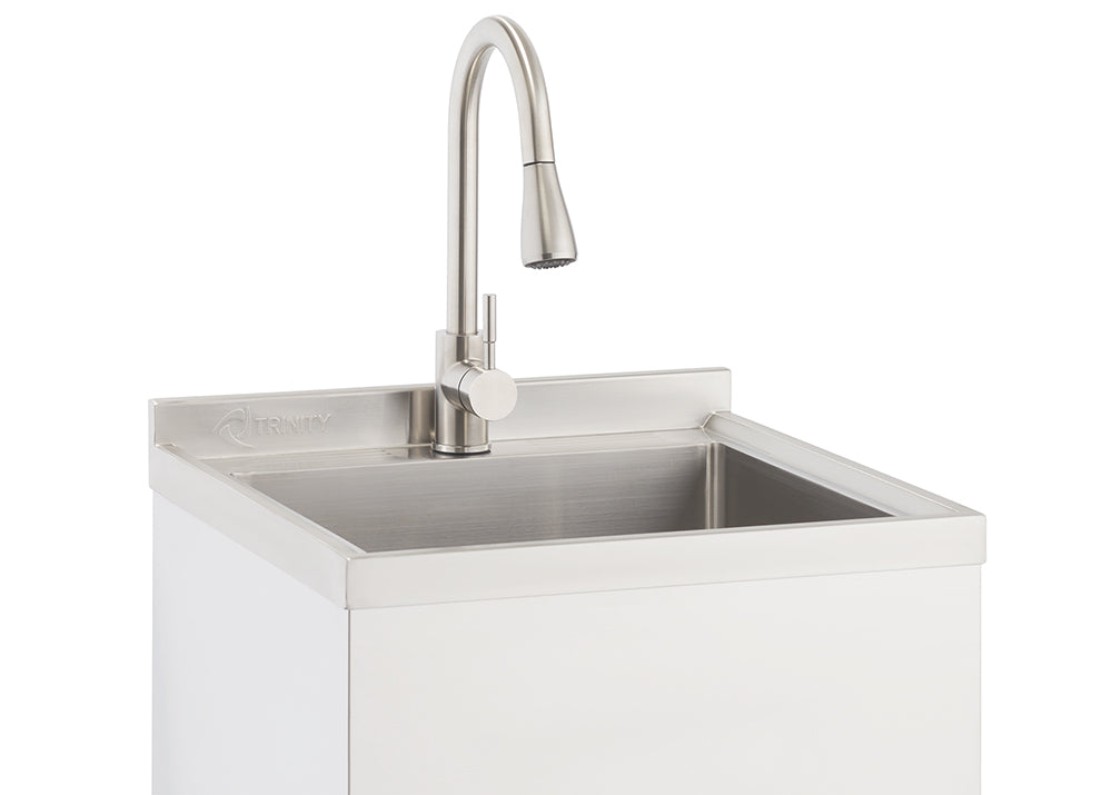 A close-up shot shows a stainless steel utility sink with a brushed nickel gooseneck faucet. The sink is integrated into a white cabinet base, and the Trinity logo is visible on the backsplash.