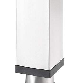 A close-up shot shows the bottom of a brushed metal square table leg, featuring a slightly tapered foot. The leg is capped with black plastic on both the top and bottom edges of the foot.
