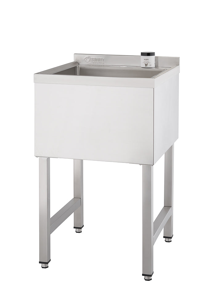 A rectangular, stainless steel utility sink with a deep basin stands on four square legs. A small, dark-colored container sits on the narrow ledge to the right of the basin.
