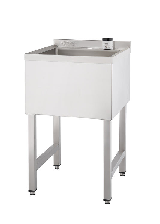 A rectangular, stainless steel utility sink with a deep basin stands on four square legs. A small, dark-colored container sits on the narrow ledge to the right of the basin.