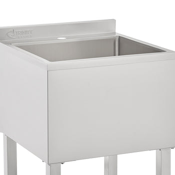 A close-up image of a square, stainless steel utility sink from the brand TRINITY BASICS. The sink is set on four metal legs and features a short backsplash with a single pre-drilled faucet hole visible.