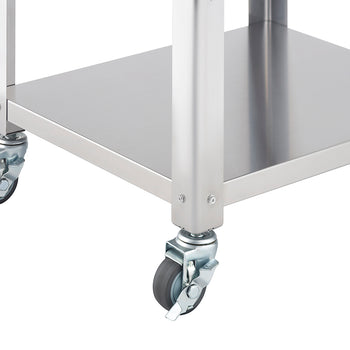 A close-up shot of the bottom corner of a stainless steel kitchen cart, showing two caster wheels and part of a stainless steel shelf. The wheels are gray with metal hardware and the shelf has a smooth, reflective surface.