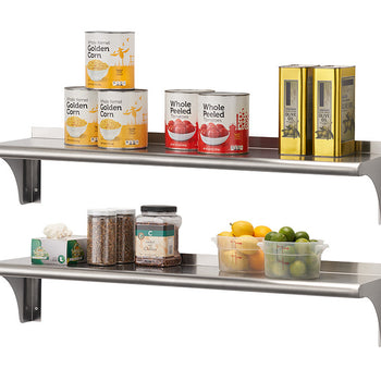 Two stainless steel shelves are mounted on a white wall, holding various food items. The top shelf contains four cans of corn, two cans of whole peeled tomatoes, and two gold-colored boxes, while the bottom shelf holds jars of dry goods, a box, and clear plastic containers of citrus fruits.
