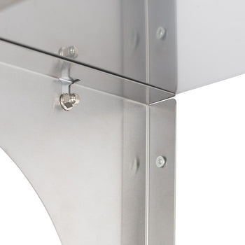 A close-up shot of the corner of a stainless steel shelf, showcasing the metal's reflectivity and the hardware used for assembly. The shelf features a rounded edge and visible screws, highlighting the industrial design and construction.