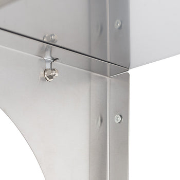 Close-up view of a shiny, stainless steel structure, possibly part of a kitchen appliance or industrial equipment. The metal sheets are joined with screws and a small latch mechanism is visible on one of the horizontal surfaces.