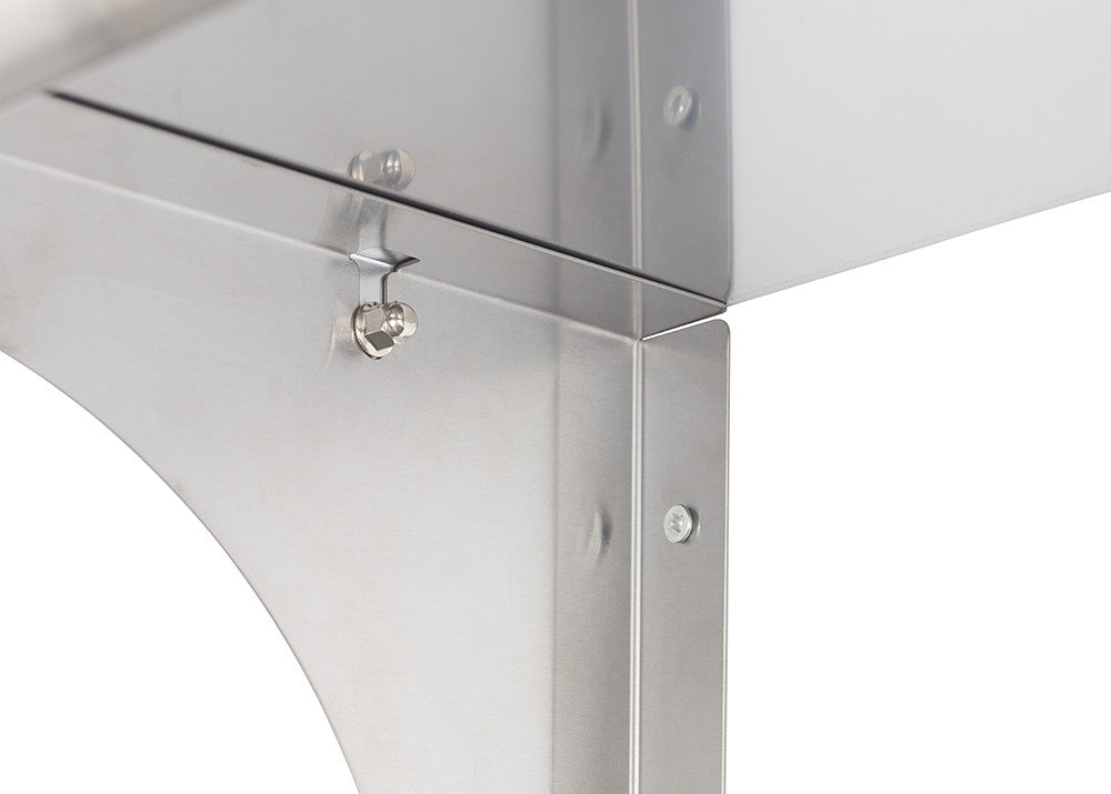 A close-up, angled view of a stainless steel wall shelf corner. The shelf features a rounded edge and a small hook attached to the side.