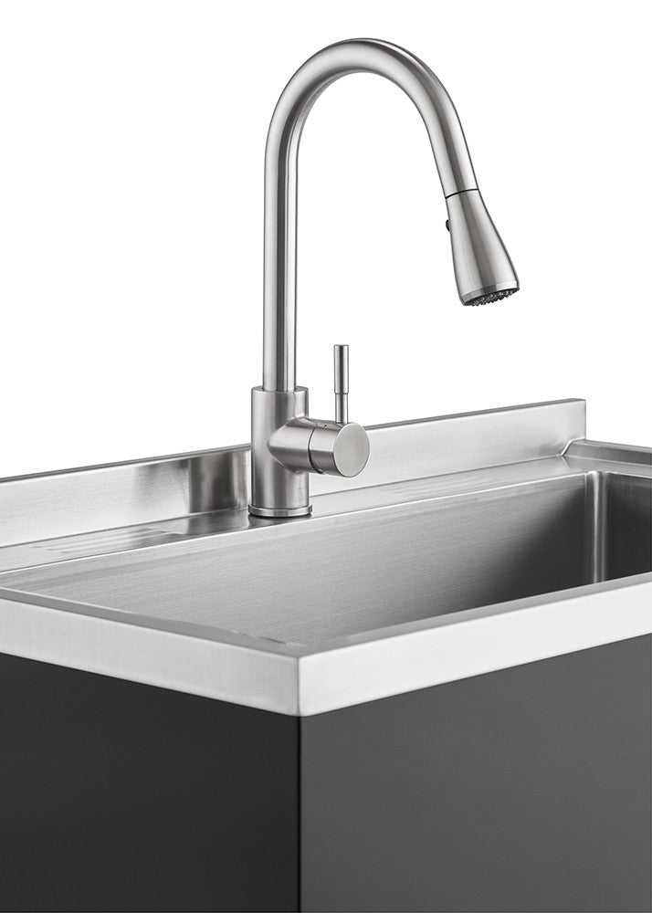 A close-up shot of a stainless steel utility sink with a modern faucet. The sink features a rectangular basin with a flat, raised rim and a dark gray cabinet base.