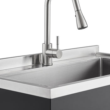 A close-up shot of a stainless steel utility sink with a modern faucet. The sink features a rectangular basin with a flat, raised rim and a dark gray cabinet base.