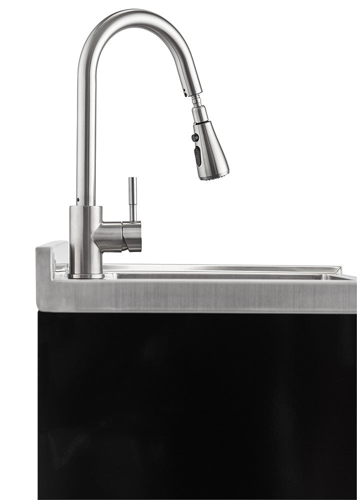 A close-up shot of a stainless steel faucet with a pull-out sprayer, installed on a stainless steel sink with a backsplash. The sink is set into a black surface, possibly a countertop or cabinet.