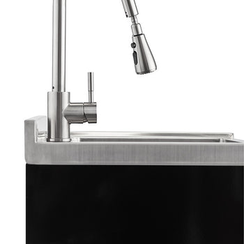A close-up shot of a stainless steel faucet with a pull-out sprayer, installed on a stainless steel sink with a backsplash. The sink is set into a black surface, possibly a countertop or cabinet.