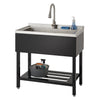 A stainless steel utility sink with a black base and a single faucet is shown against a white background. The sink has a small backsplash and a wire shelf underneath.