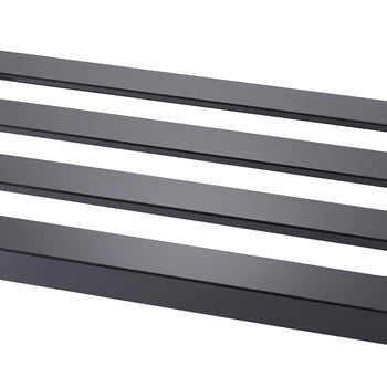 A close-up angled shot of a black metal surface with three evenly spaced rectangular cutouts. The metal has a smooth, matte finish and the cutouts reveal a lighter-colored surface beneath.