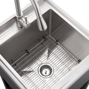 A top-down view shows a stainless steel utility sink with a brushed metal gooseneck faucet. A metal grid rack sits at the bottom of the basin, and the sink is set into a dark-colored cabinet base.