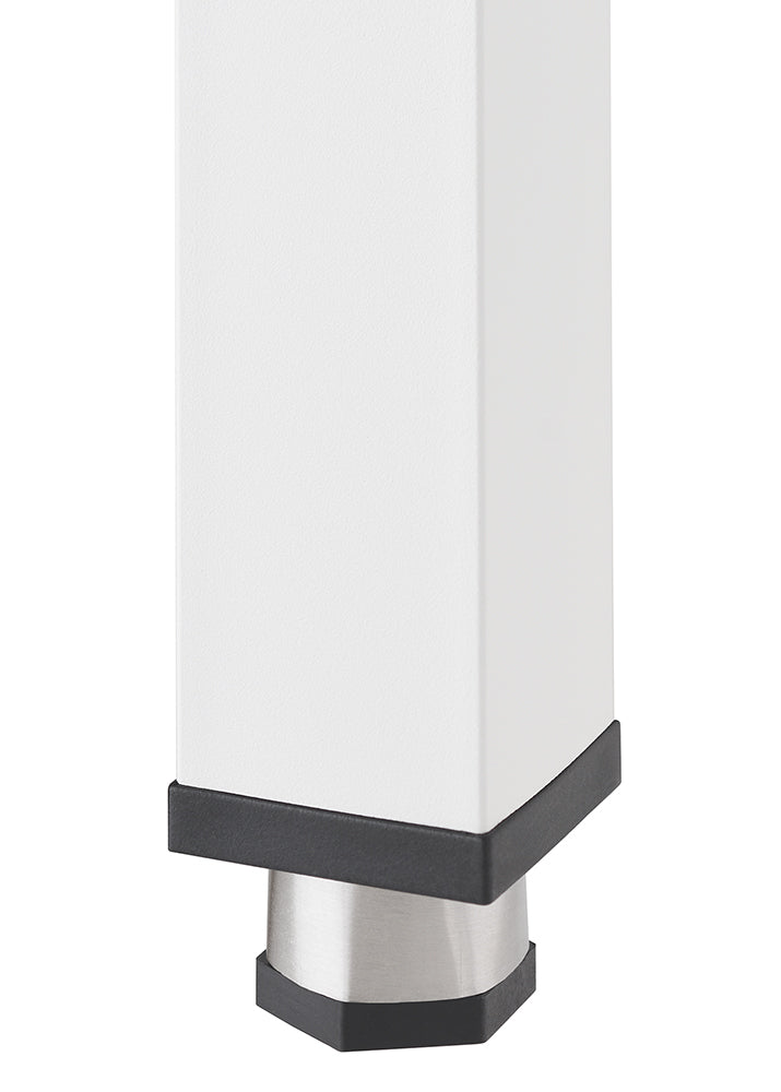 A close-up shot shows the bottom of a white rectangular table leg with a black base. Beneath the black base, a silver, slightly tapered foot extends downwards, also with a black tip.