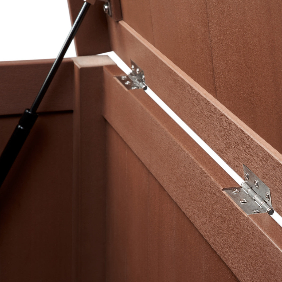 A close-up shot shows the hinges of an open brown outdoor deck box. The metal hinges are attached to the lid and the body of the box, allowing it to open and close.