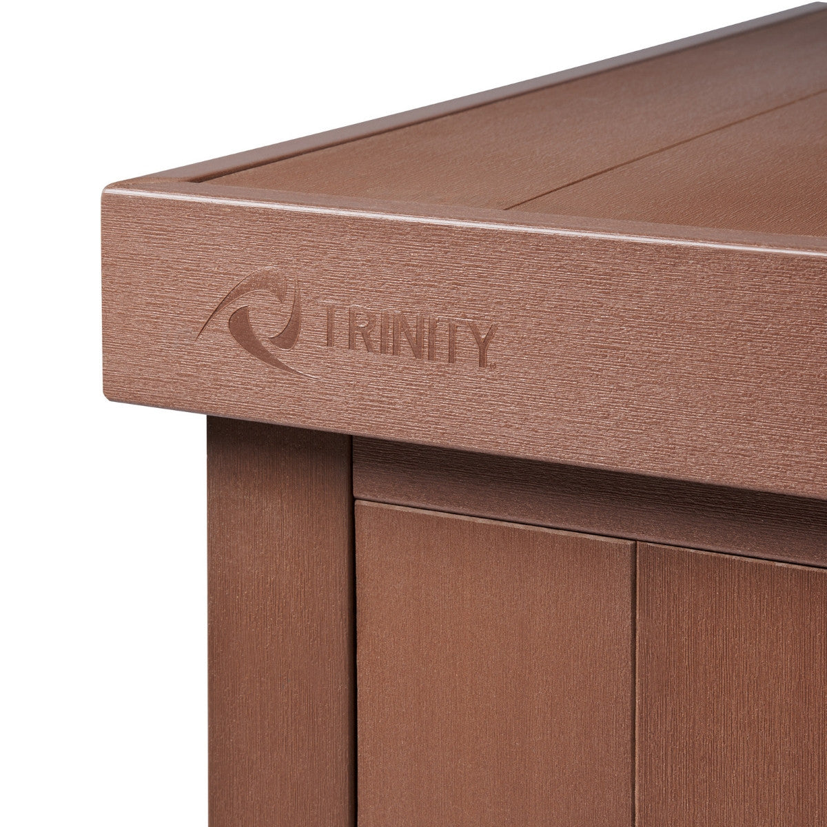 A close-up shows the corner of a brown outdoor deck box. The brand name "TRINITY" is embossed along the top edge.