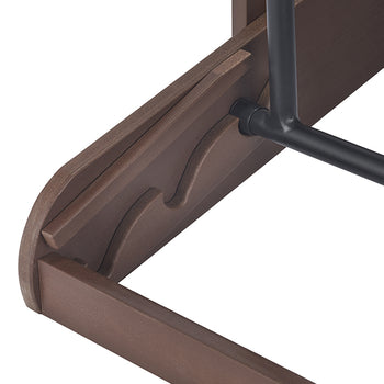 A close-up shot shows the underside of a brown wooden shelf with two wavy indentations designed to hold a black metal rod in place. The rod is secured by a black bolt on the underside of the shelf.