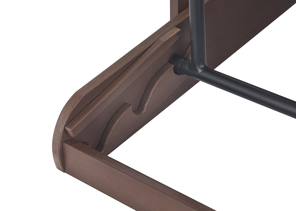 A close-up shot shows the underside of a brown wooden shelf with two wavy indentations designed to hold a black metal rod in place. The rod is secured by a black bolt on the underside of the shelf.