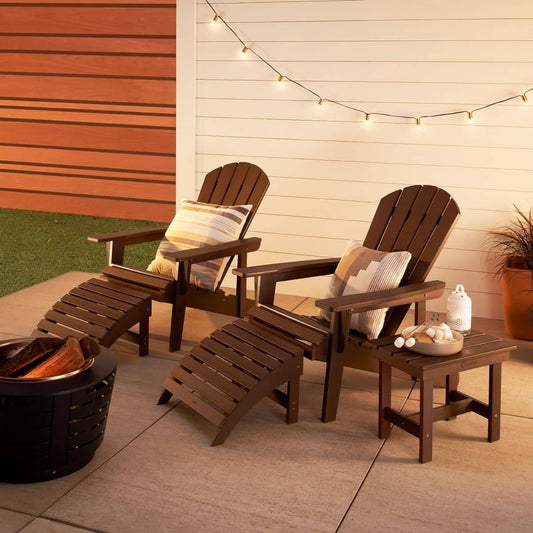 A 5-Piece Adirondack set, featuring two dark brown Adirondack chairs with matching ottomans and a small side table. The set is arranged on a patio with string lights overhead, creating a cozy outdoor setting.