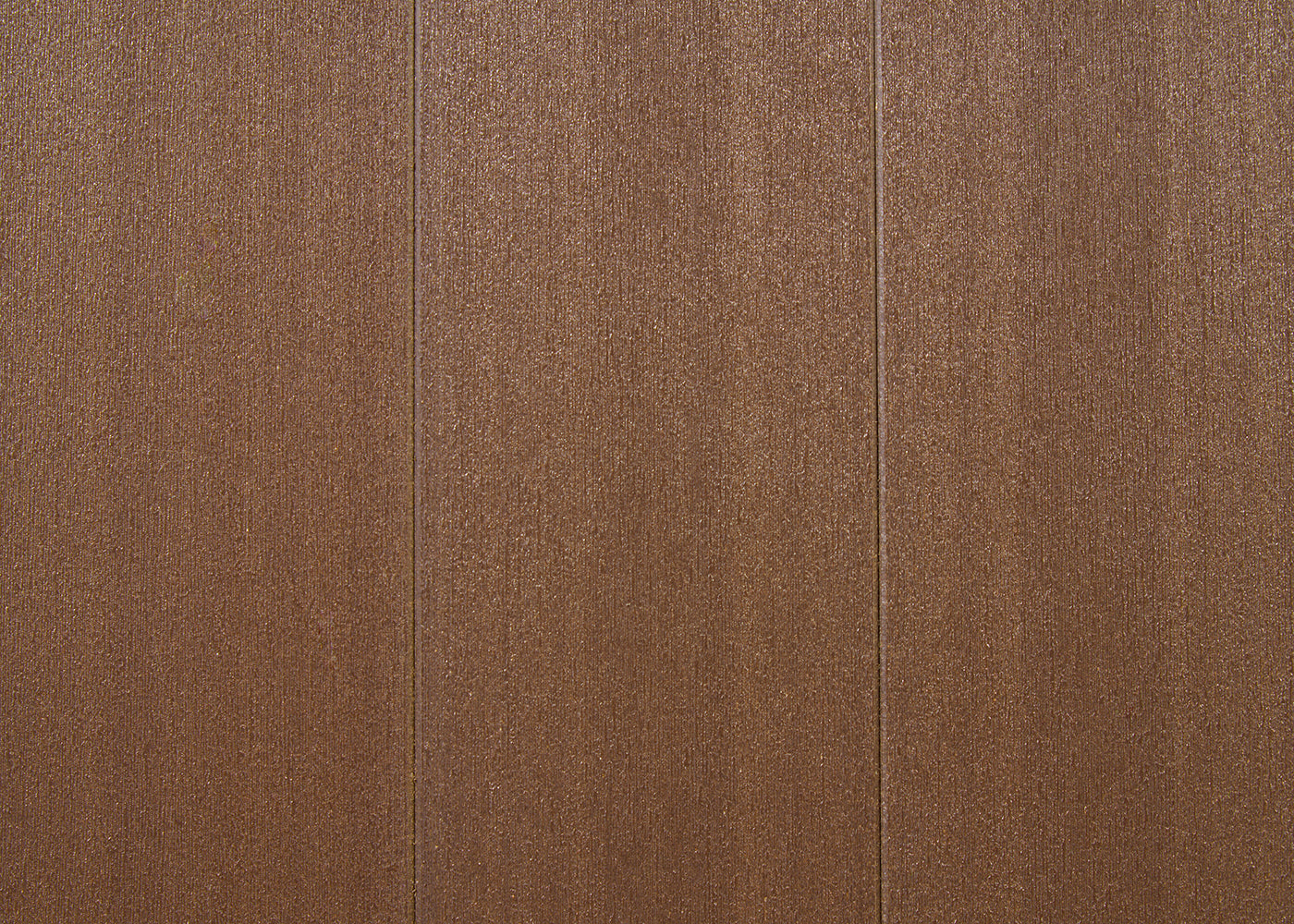 A top-down shot shows a brown, textured surface that appears to be made of three vertical panels. Each panel has a subtly ridged or brushed texture running vertically, creating a slight shimmering effect in the light.