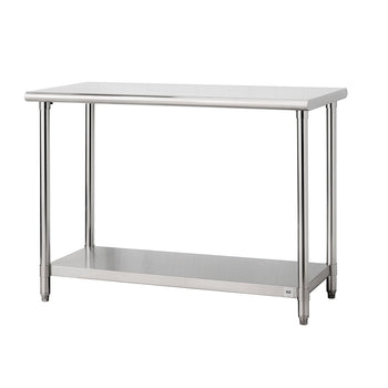 A stainless steel utility table with a rectangular top and four cylindrical legs is shown against a white background. The table also features a lower shelf for storage with trinity logo on the left side.