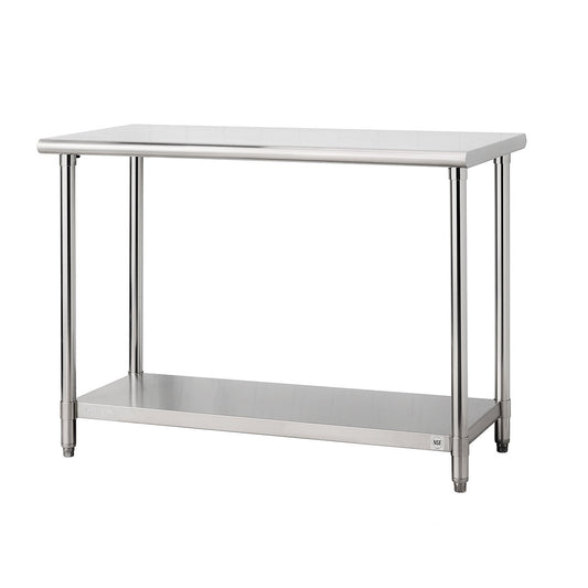A stainless steel utility table with a rectangular top and four cylindrical legs is shown against a white background. The table also features a lower shelf for storage with trinity logo on the left side.