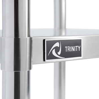 A close-up shot shows a section of a stainless steel prep table. A black rectangular label with a white border reads 