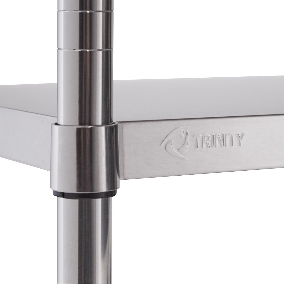 A close-up shows a shiny, stainless steel shelf connected to a round, metallic pole. The word "TRINITY" is subtly embossed on the edge of the shelf.
