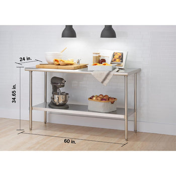 A 60 inches wide by 24 inches deep by 35 inches high trinity stainless steel prep table. The top shelf holds various kitchen items including bowls, cutting boards, and jars, while the bottom shelf contains a stand mixer and a basket of onions.