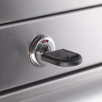 A close-up of a Stainless Steel Tool Chest Combo. A key is inserted into the lock.