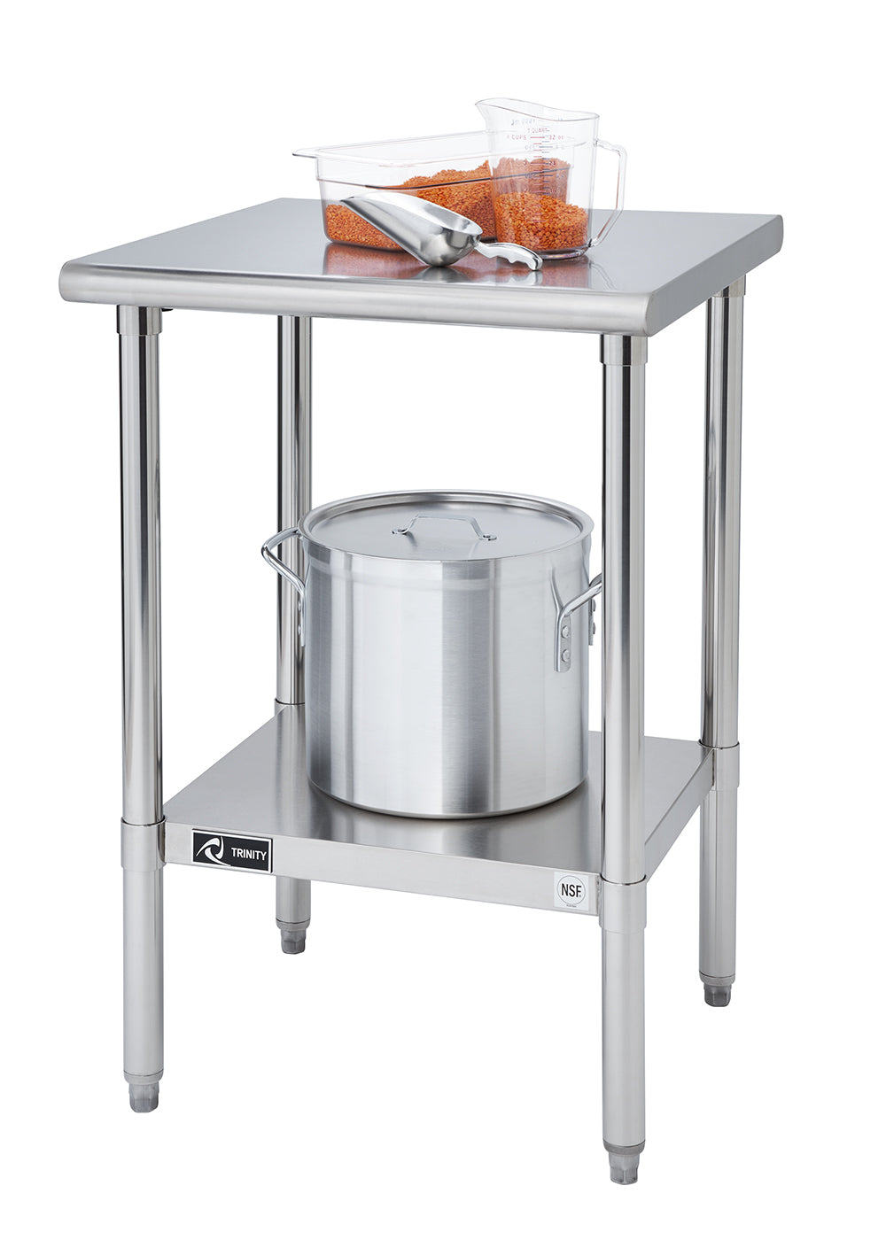 A stainless steel two-tiered table stands against a white background. On the top shelf, there is a clear rectangular container with orange contents and a metal scoop, along with a clear measuring cup also containing the orange material. A large stainless steel pot with a lid sits on the lower shelf.