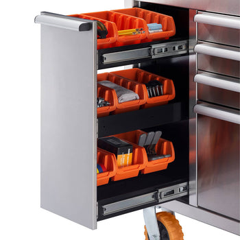 A close-up shows a section of a stainless steel rolling workbench. Three pull-out drawers are visible, each containing several orange plastic bins filled with various tools and hardware.