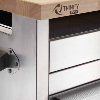 A close-up shows the corner of a stainless steel rolling workbench. The workbench features a light-colored wooden raised top with the 