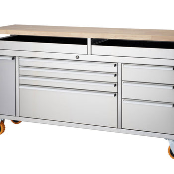 A stainless steel rolling workbench with a light-colored wooden top is shown against a white background. The workbench features multiple drawers of varying sizes, a side cabinet with a door, a central locking mechanism, and orange caster wheels with brakes.